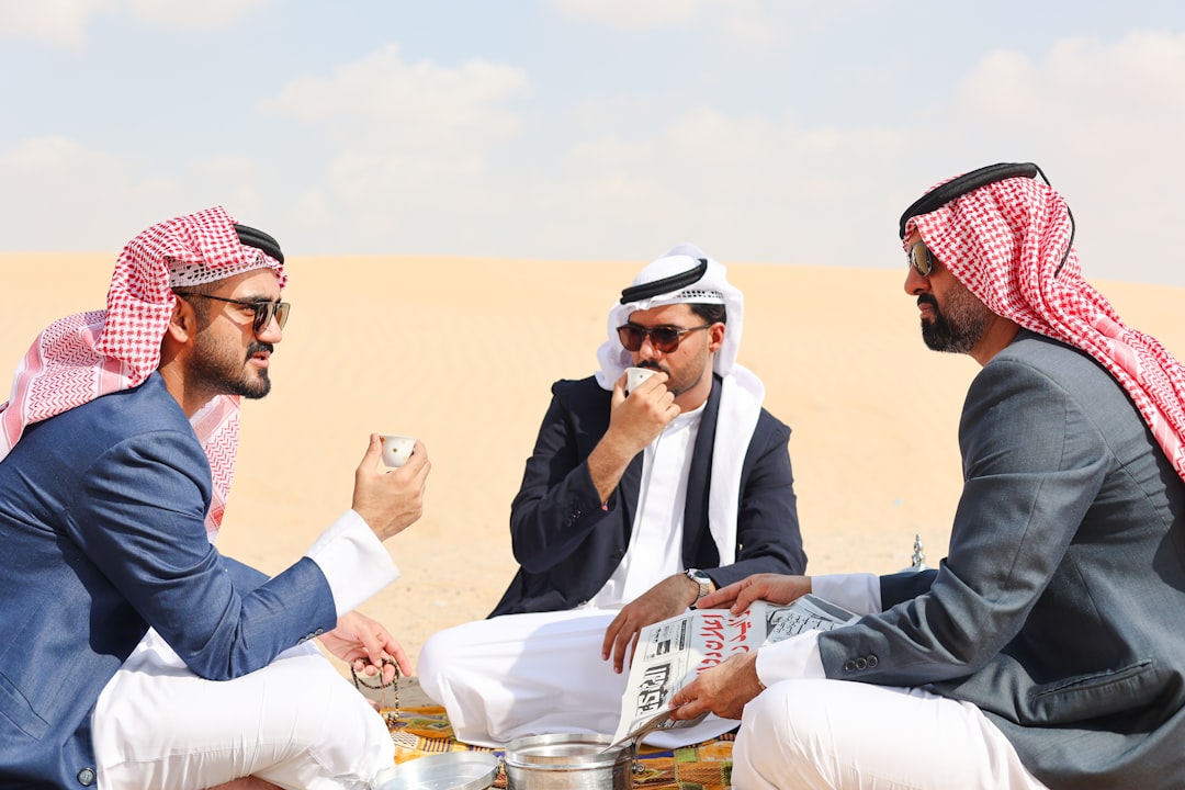 A group of professionals discussing web applications in a modern Dubai office.